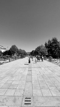 Black and white photo of people walking on a scenic walkway in Braga, Portugal.