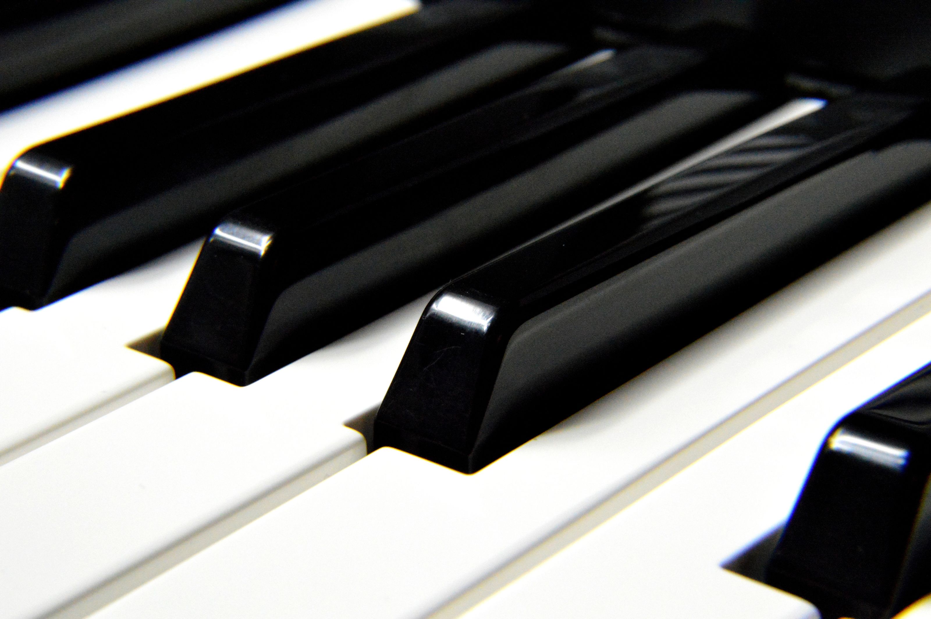 A detailed close-up shot focusing on black and white piano keys, highlighting musical harmony.