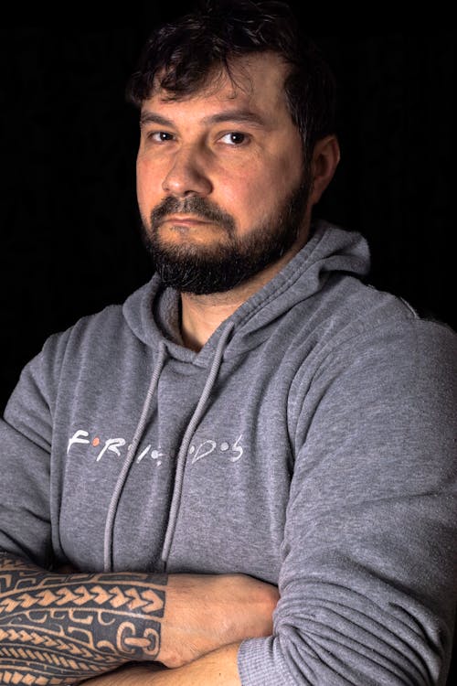 Portrait of a Bearded Man with an Arm Tattoo 