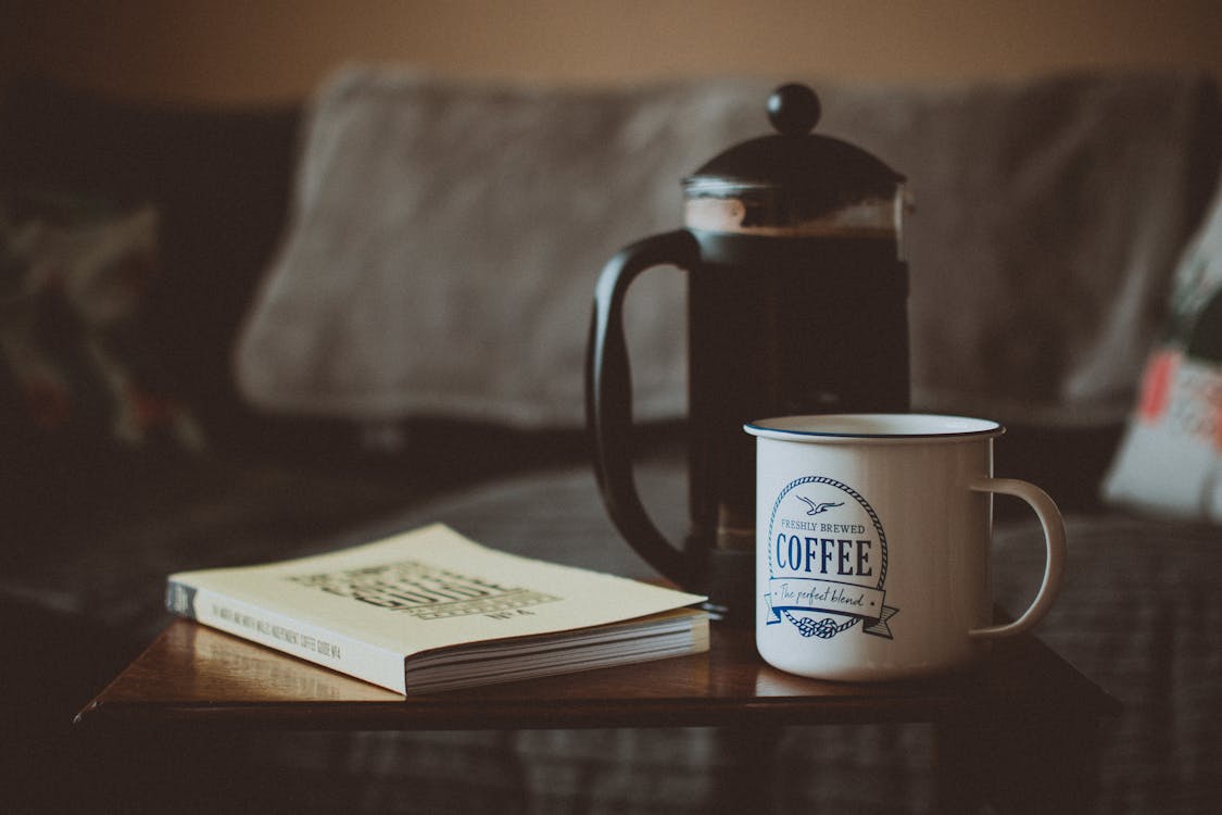 Free Closed Book Beside French Press and Mug Stock Photo