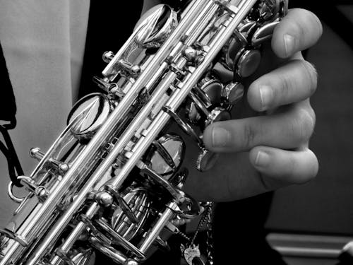 Pessoa Segurando Saxofone Em Fotografia Em Escala De Cinza