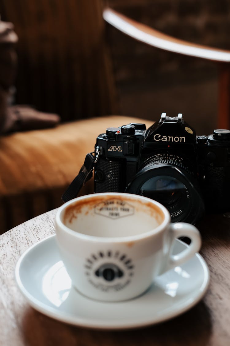 Empty Coffee Cup And Camera Behind