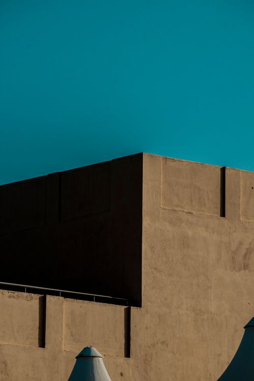 Free Clean architectural design of a building in Dubai with a minimalist aesthetic and clear sky backdrop. Stock Photo