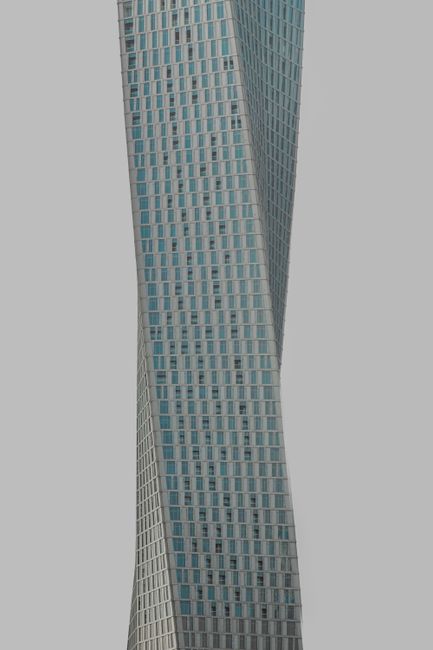 A stunning vertical shot of the renowned twisting structure, Cayan Tower in Dubai.
