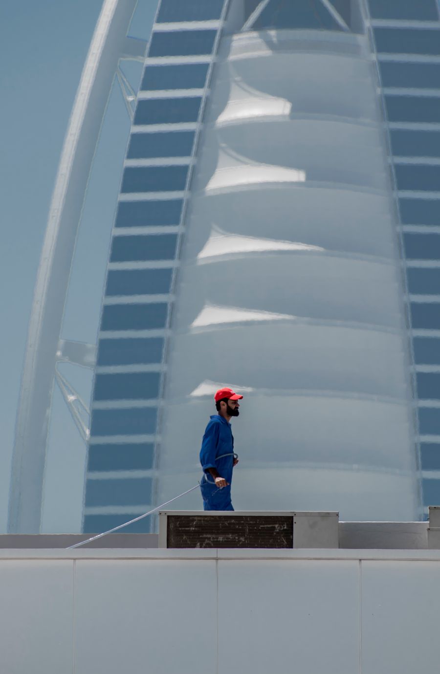 Construction worker on a Dubai site with the Burj Al Arab behind