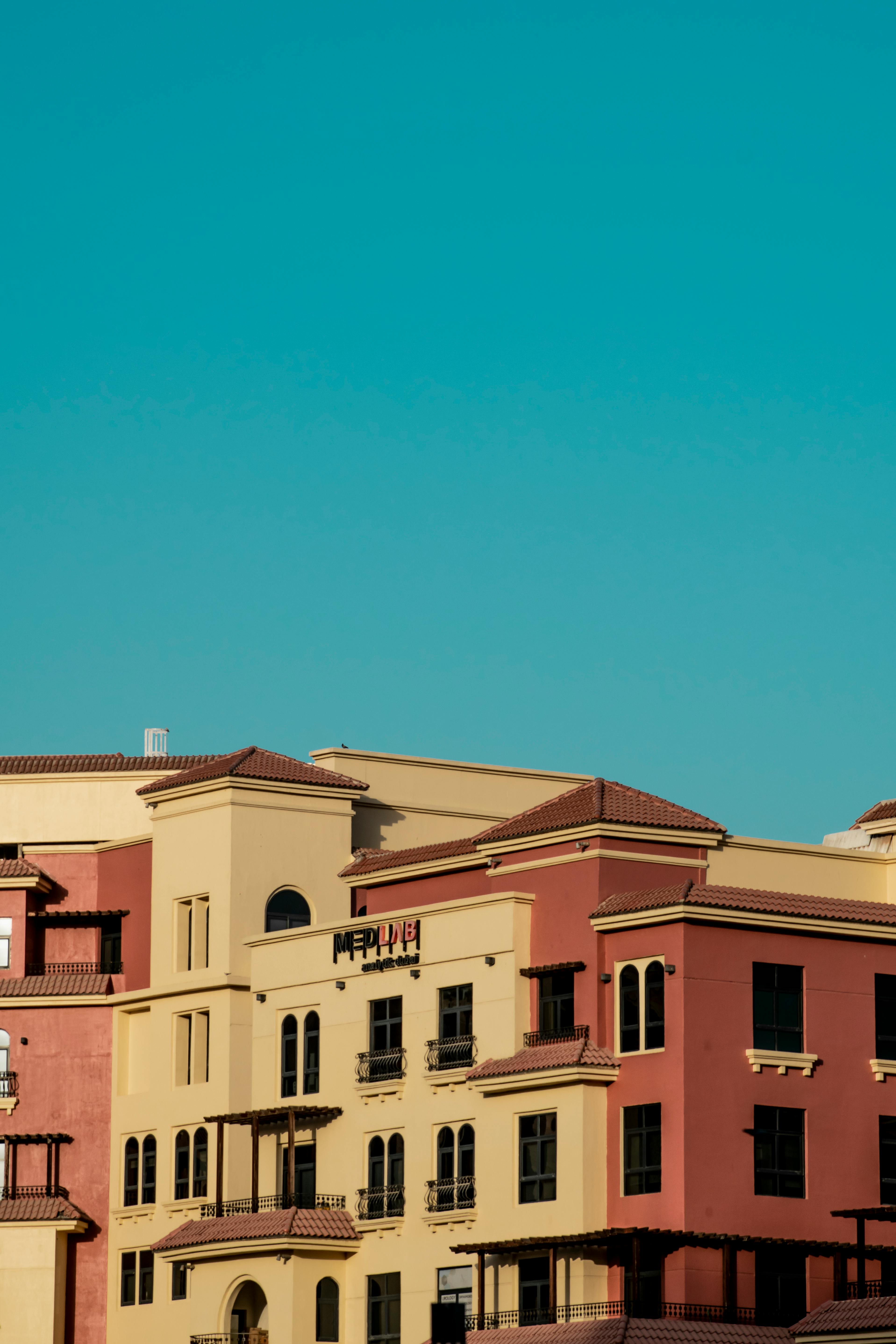 Modern apartment complex under a bright blue sky in Dubai, featured in the UAEThrive Daily News Roundup