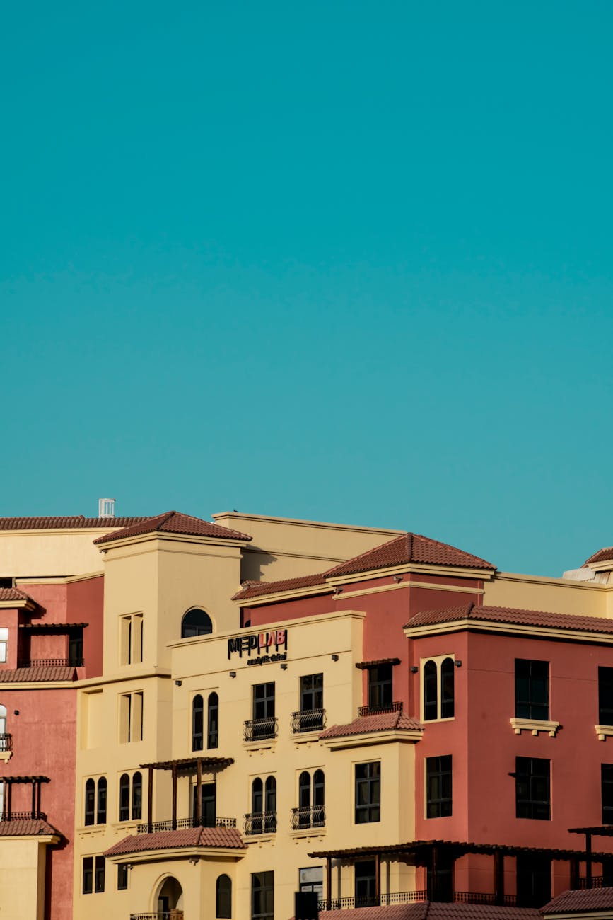 Modern apartment complex under a bright blue sky in Dubai, featured in the UAEThrive Daily News Roundup