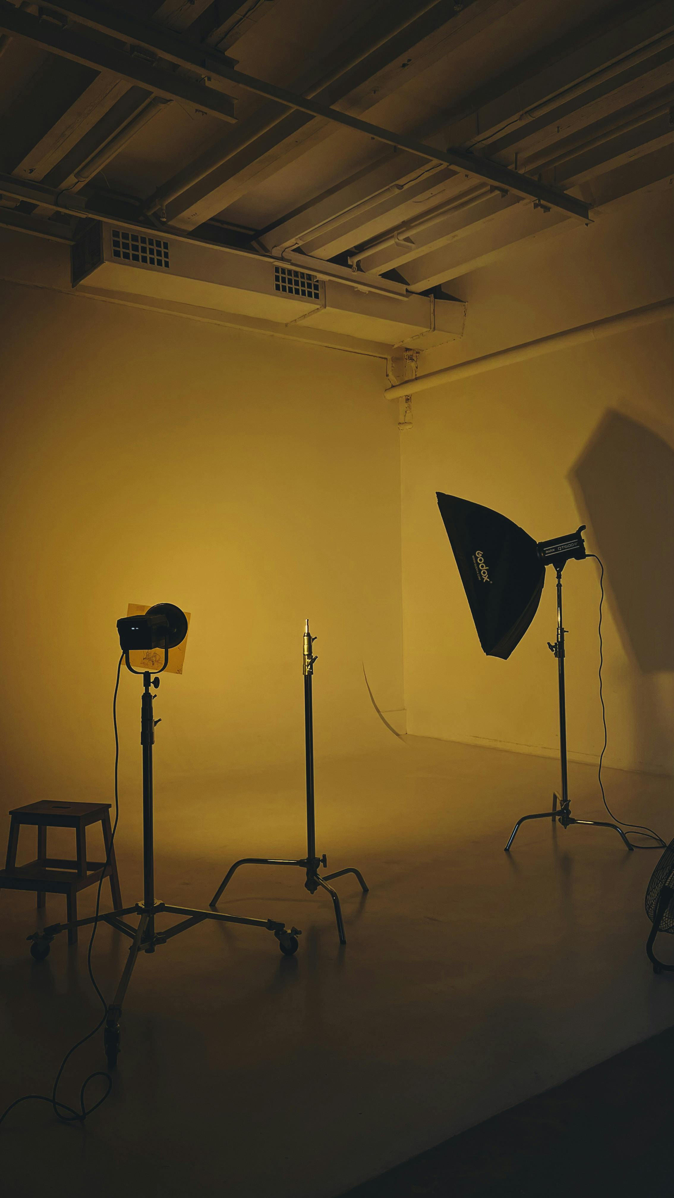 Experience a modern studio setup with soft yellow lighting and professional equipment.
