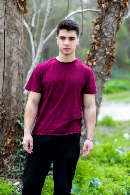 Man Posing in T-shirt with Trees behind