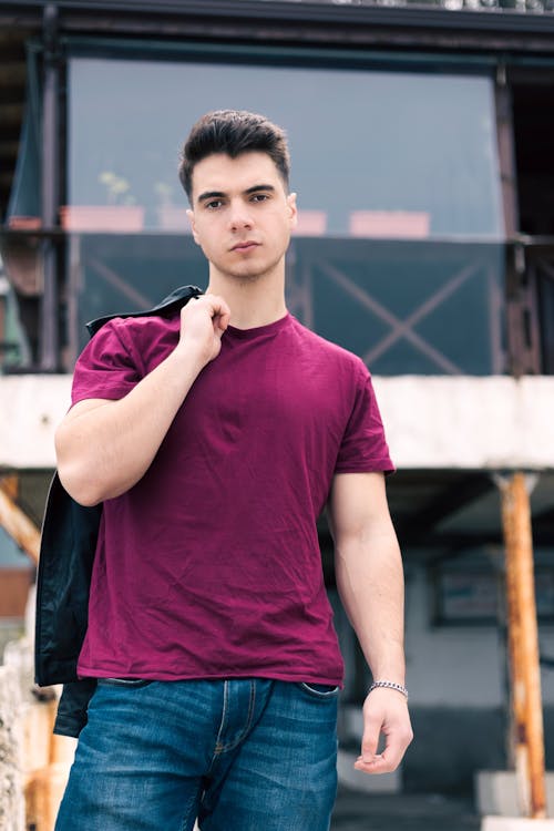 Young Man in Casual Clothes Posing in City 