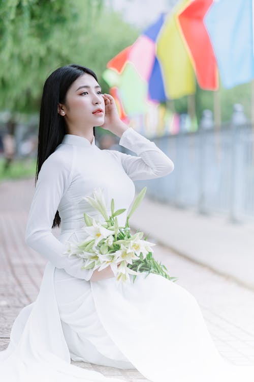 Bride Sitting and Posing in Wedding Dress