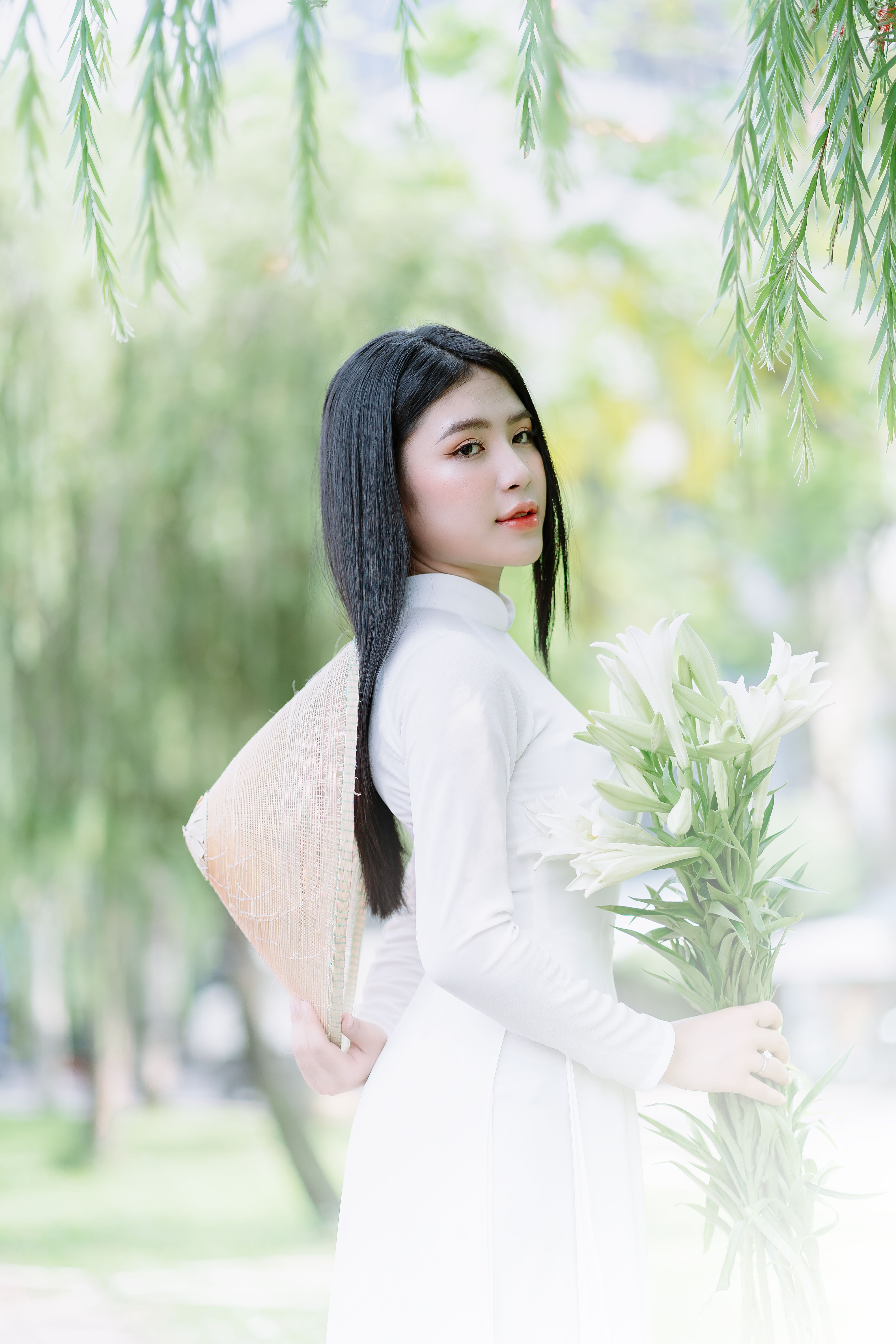 Young Woman in a White Dress Holding a Bouquet of White Lilies · Free ...