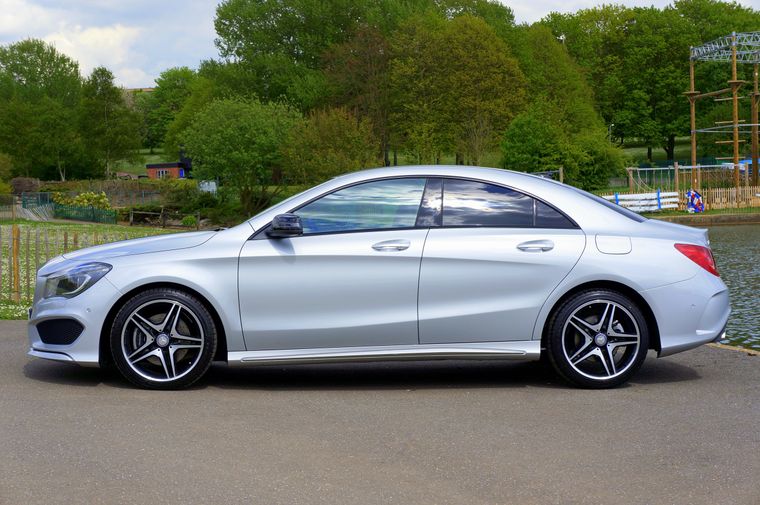 Side view of a silver luxury saloon parked on a road — photo by Mike Bird on Pexels