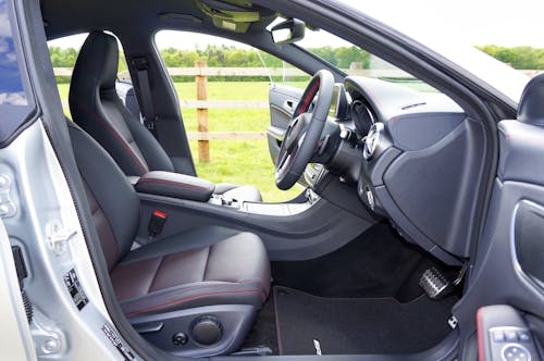Free Explore the elegant design of this modern car interior, showcasing comfortable seating and a sleek dashboard. Stock Photo