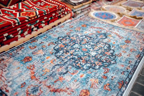 Free A collection of traditional handmade carpets with vibrant patterns on display. Stock Photo