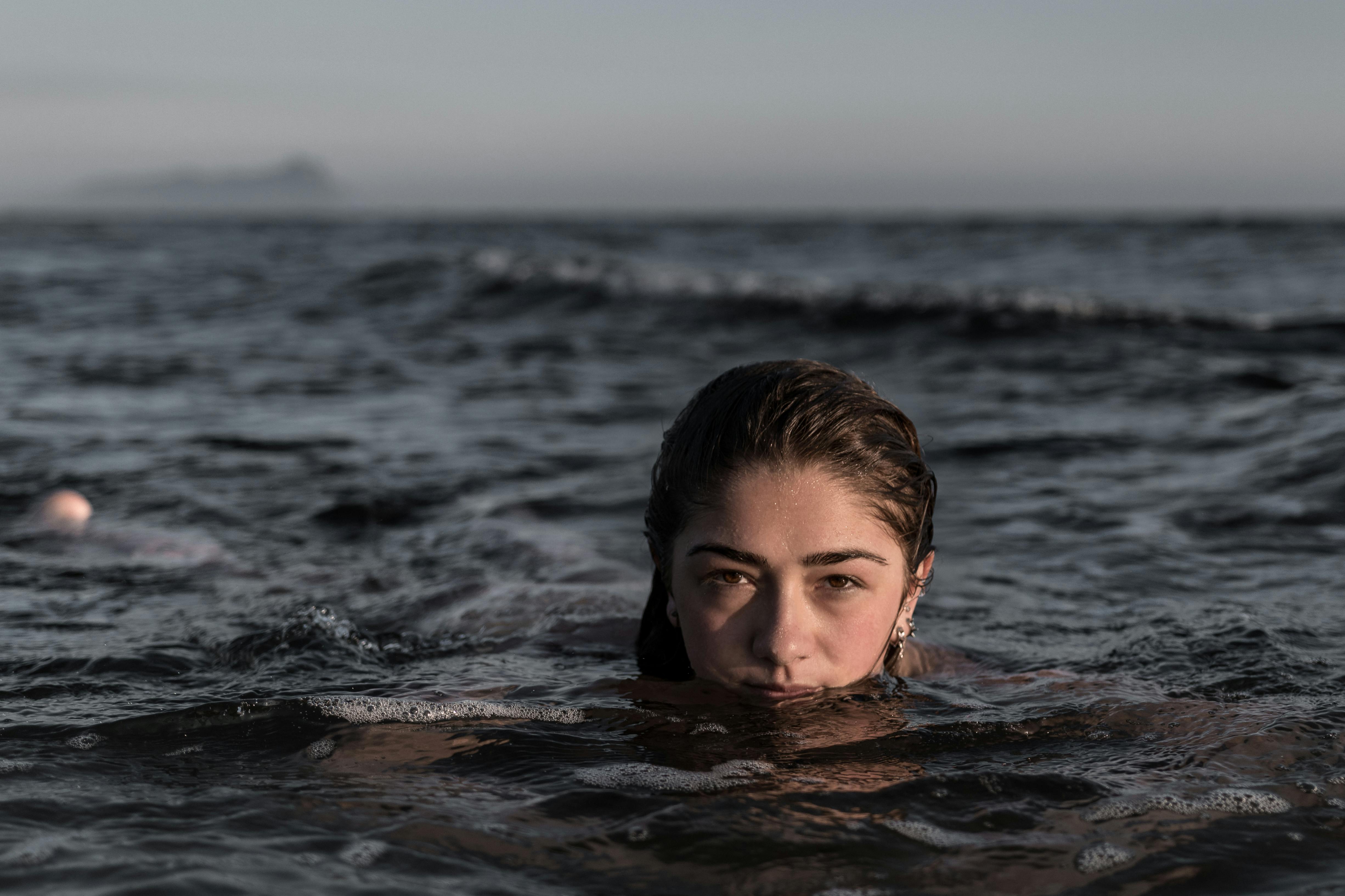 A Human Hand Off The Water's Surface · Free Stock Photo