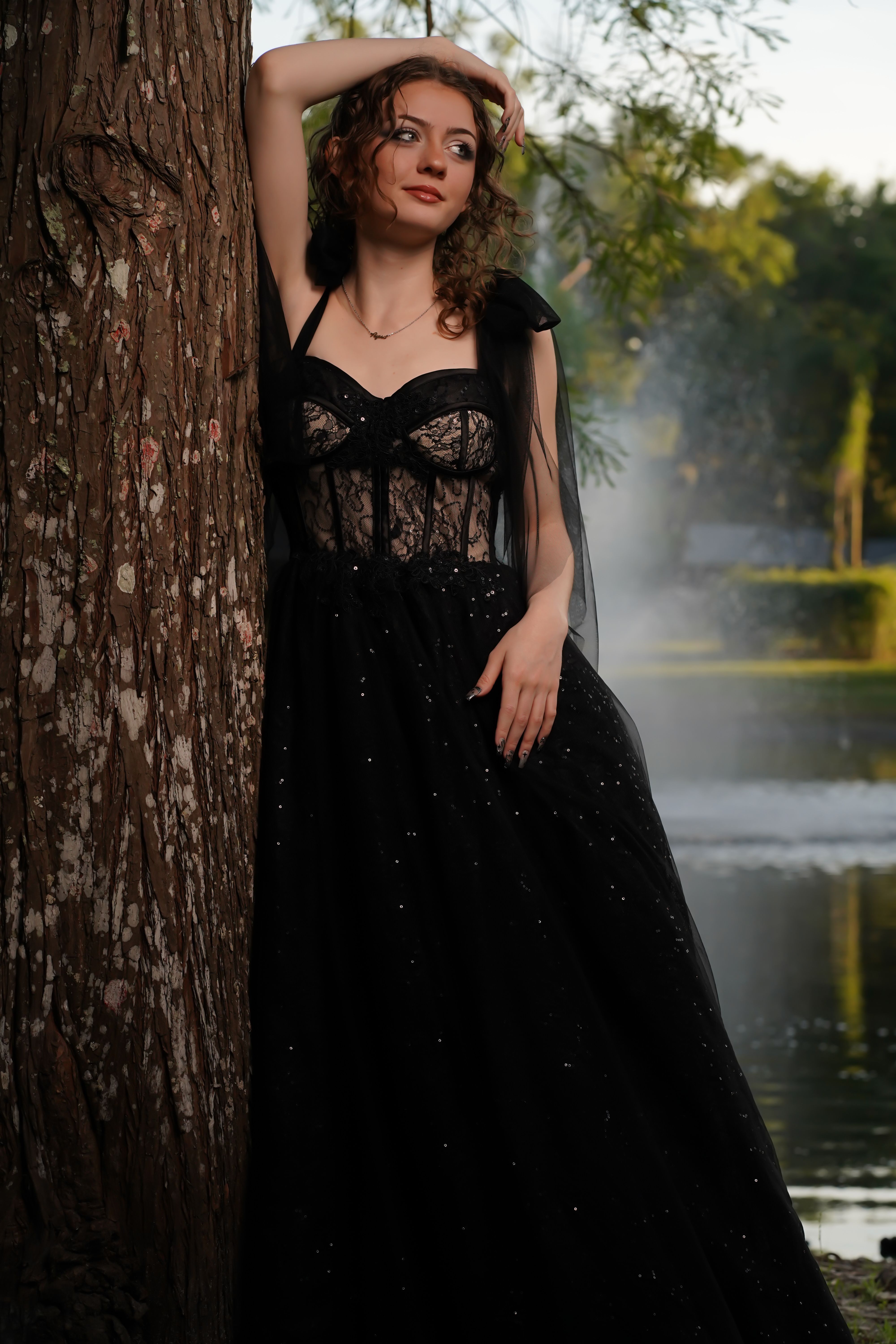 Woman in Black Prom Dress Leaning against Tree · Free Stock Photo