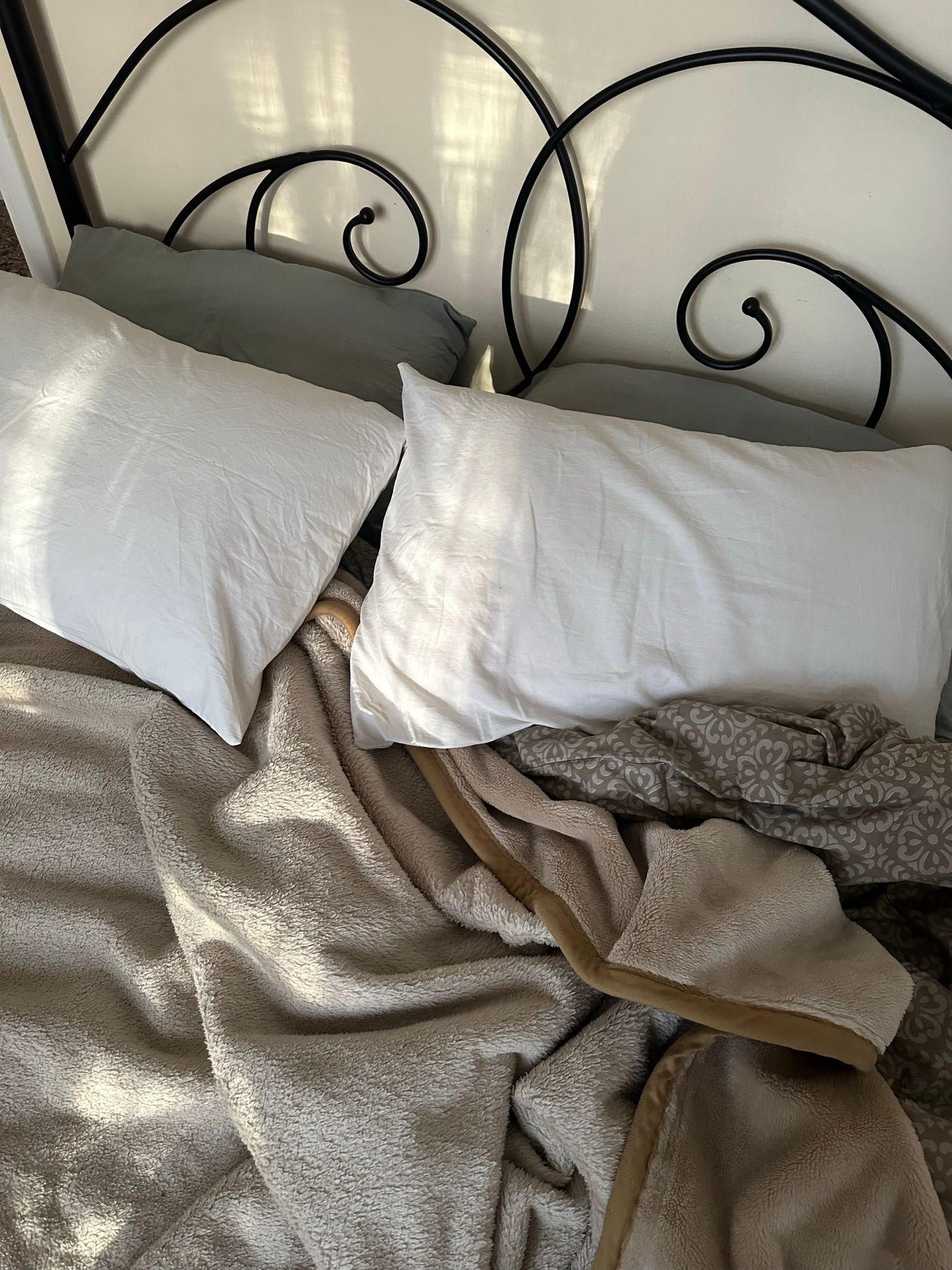 An inviting bed layered with soft blankets and pillows