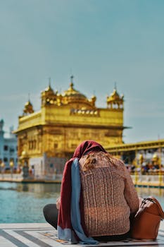 A woman sits near the Golden Temple in Amritsar, India, enjoying a peaceful moment.
