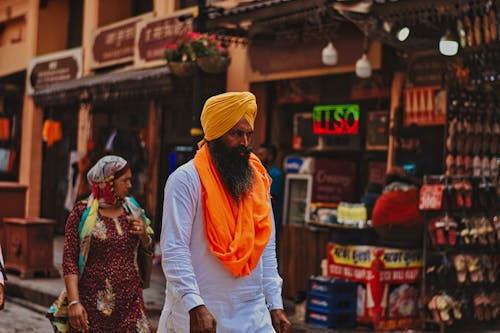 Man in a Turban Walking through the Street Market 