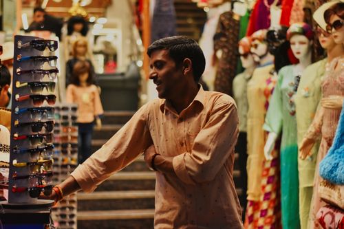 Indian shop owner smiling in his store