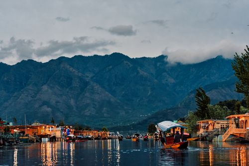 Free A peaceful view of Dal Lake in Srinagar with colorful boats against the backdrop of majestic mountains. Stock Photo