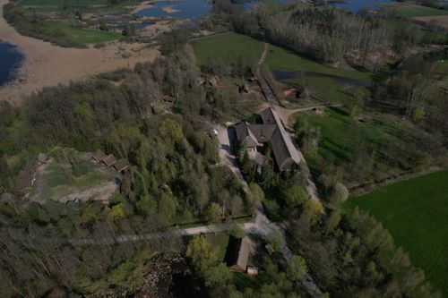 Free A stunning aerial shot of the ancient Biskupin village in Poland, surrounded by lush greenery. Stock Photo