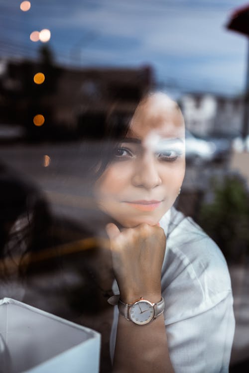 Face of Woman Posing behind Window