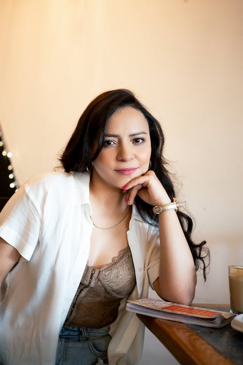 Portrait of a Young Brunette Sitting at a Table