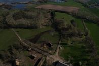 Aerial view showcasing the Biskupin archaeological site, highlighting its historic layout and rural landscape.