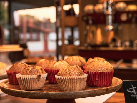 Delicious muffins displayed on a cakestand in a cozy kitchen setting.