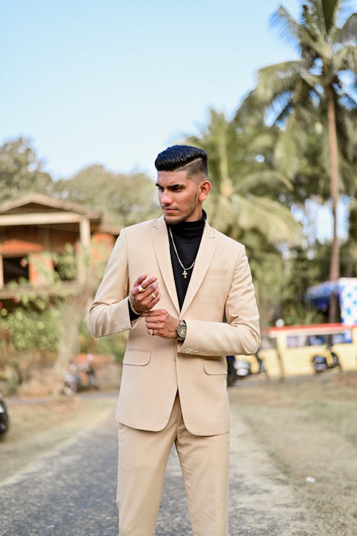 Fashionable Man in a Beige Suit Standing Outside 