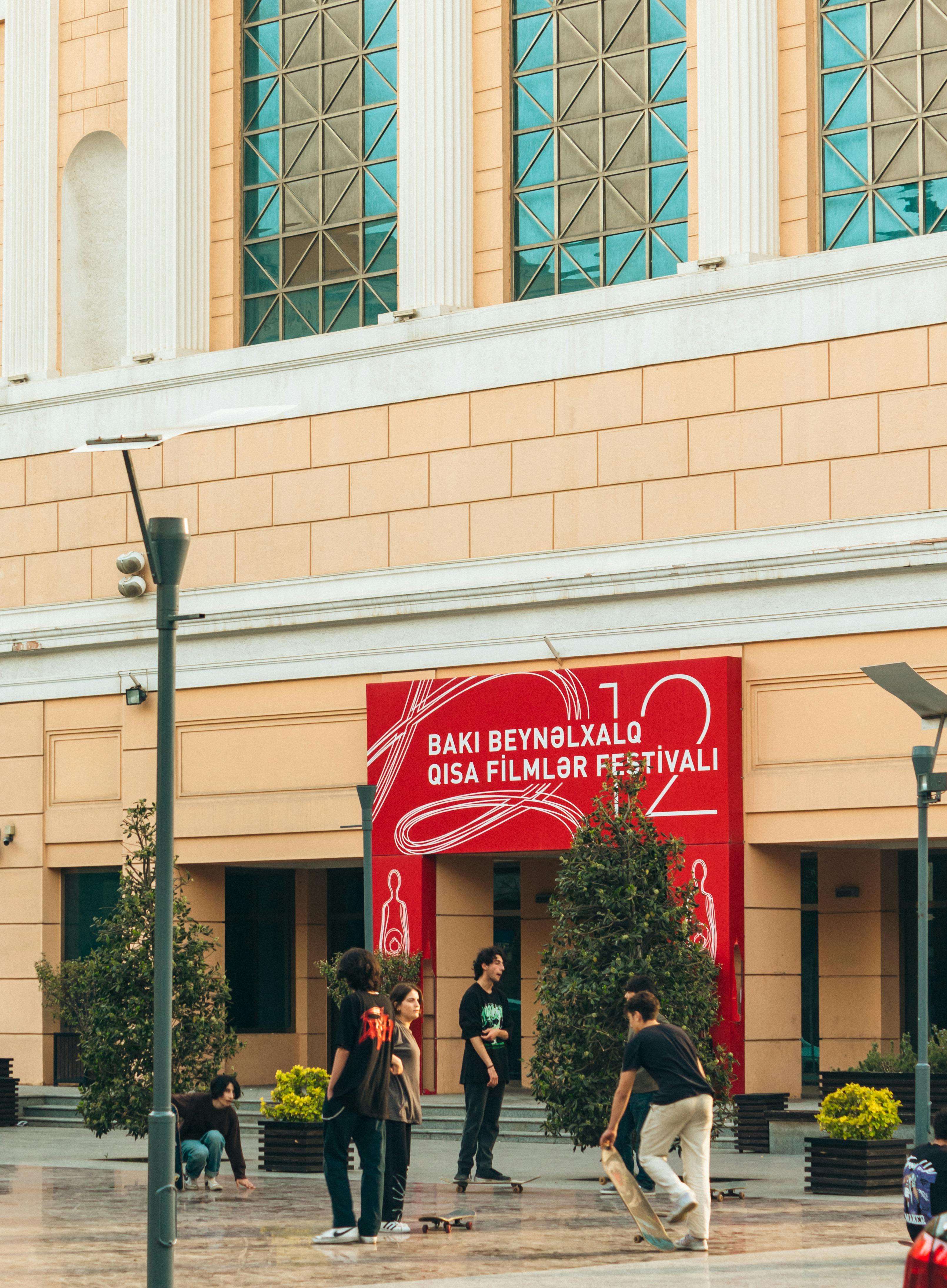 People socialize outside the Nizami Cinema Center in Baku during a film festival.