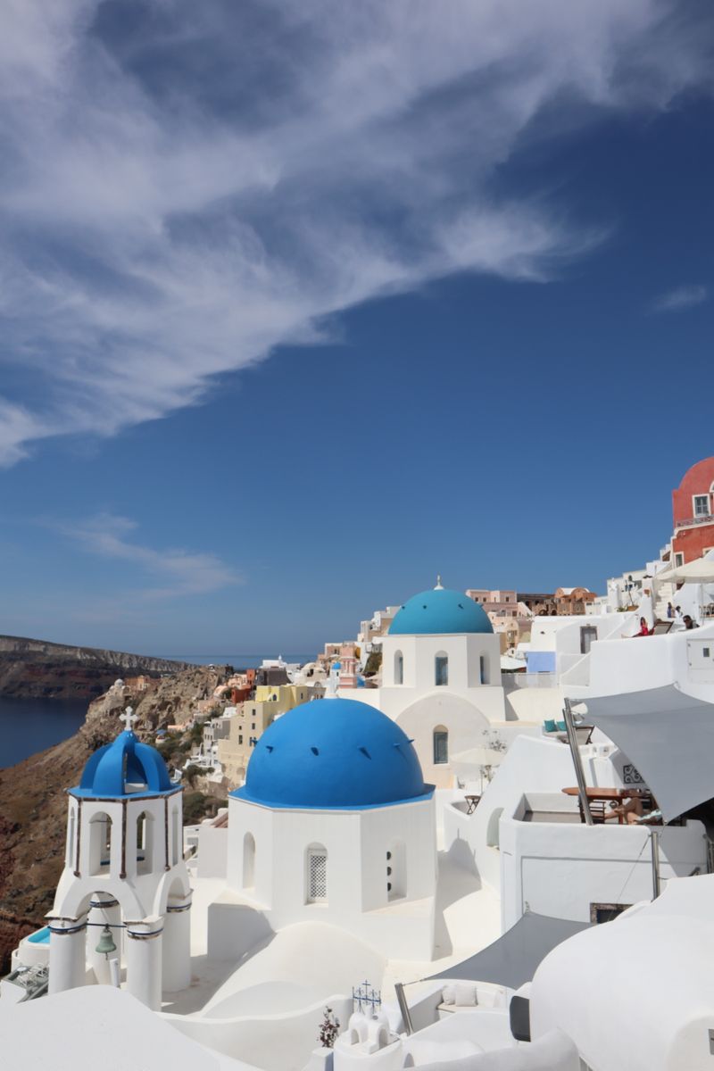 Blue domed churches against the sky in Oia, Santorini