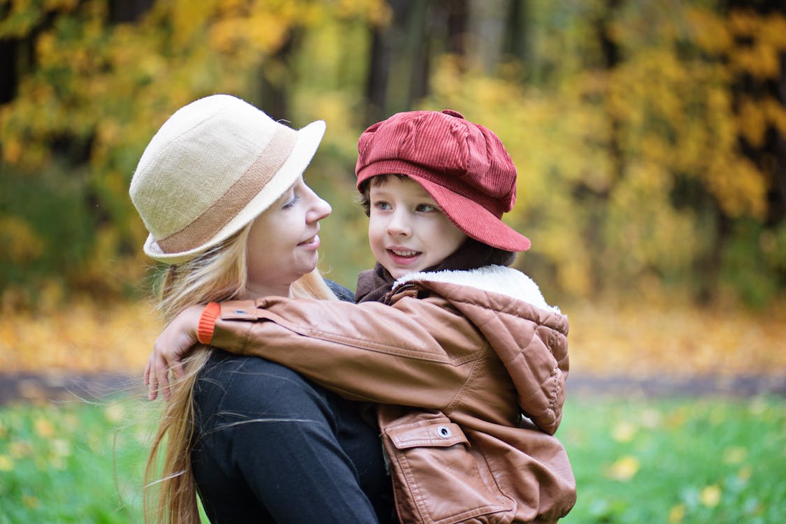 Woman Carrying Girl on Outdoors