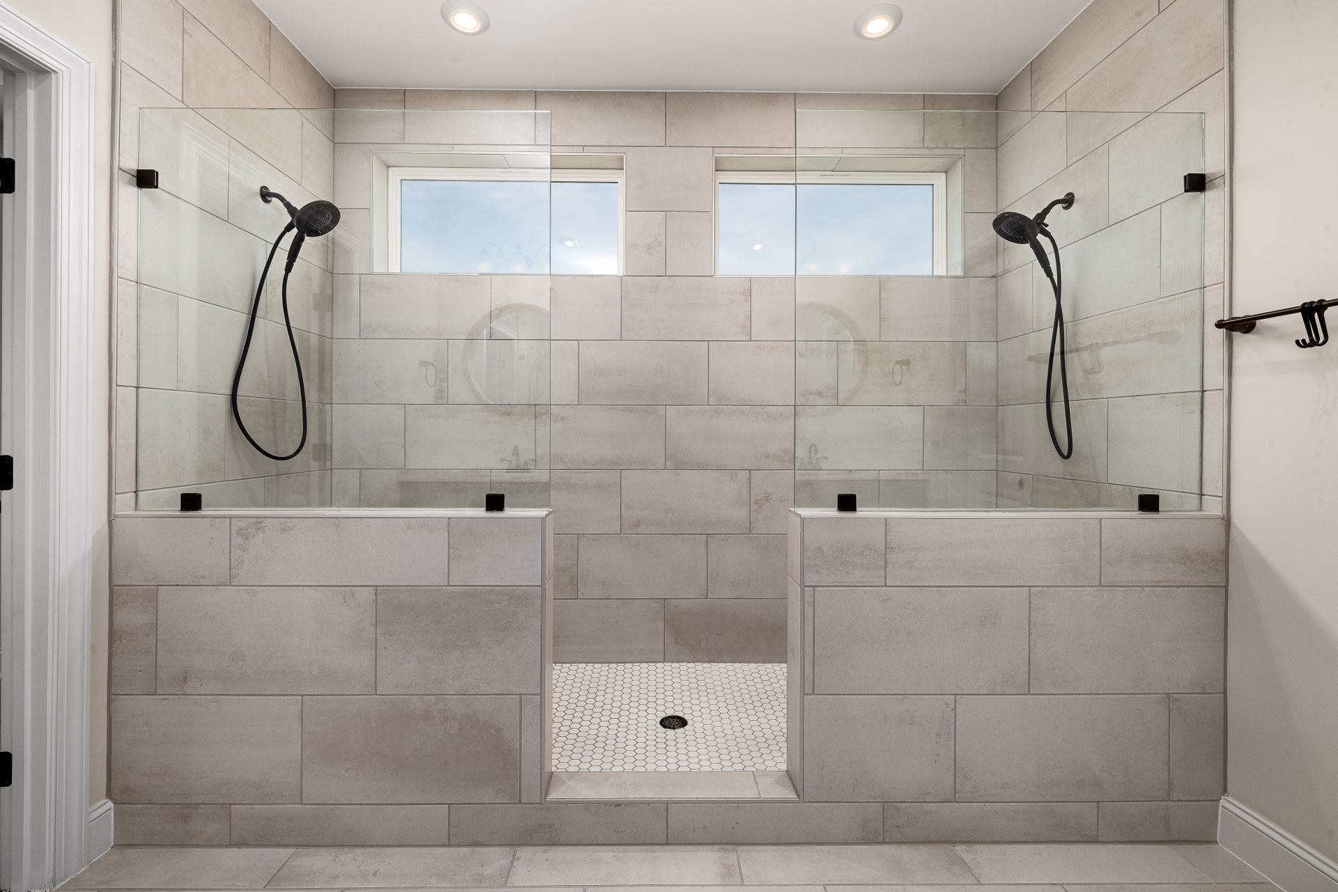 A sleek, contemporary dual shower bathroom featuring elegant tile work and modern fixtures.