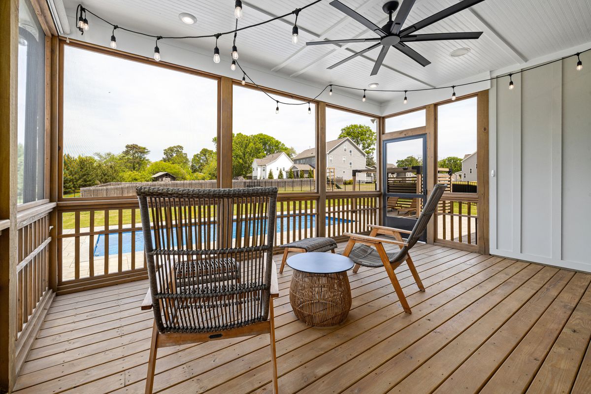 Screened lanai with patio furniture overlooking pool — Florida screen room