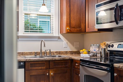 Stylish kitchen interior featuring wooden cabinets, stainless steel appliances, and a cozy atmosphere.