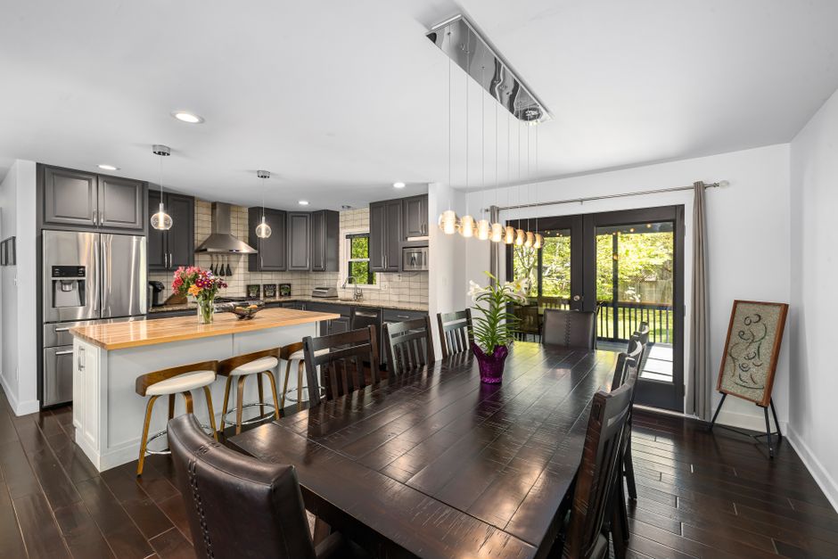 Photo by Curtis Adams on Pexels Spacious kitchen with dining room, modern decor, and natural light.