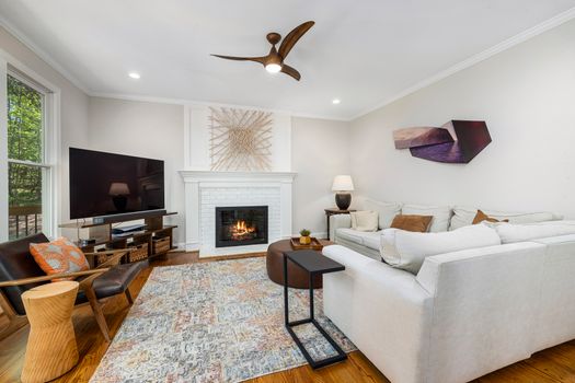 Stylish and cozy living room featuring a fireplace, modern furniture, and contemporary decor.
