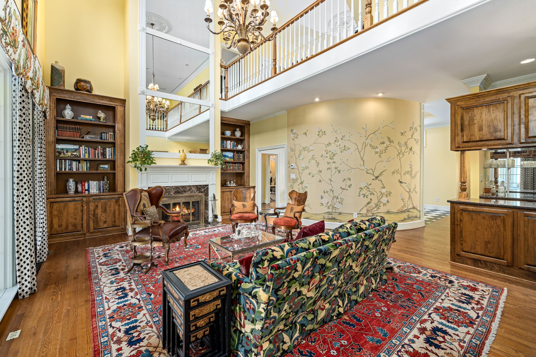 Formal living room with upholstered sofa and chairs grouped around a central table