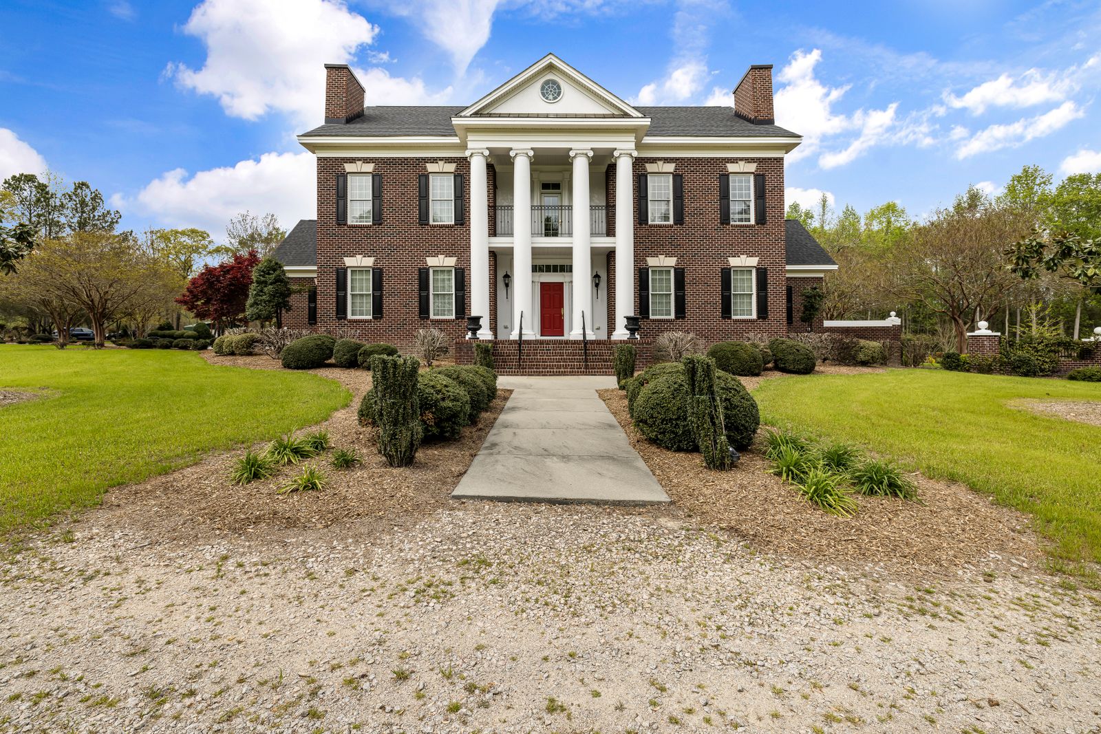 Large two-story red-brick custom home with a white four-column portico, black shutters, and a symmetrical facade framed by manicured landscaping, Jefferson Estates, Naperville IL