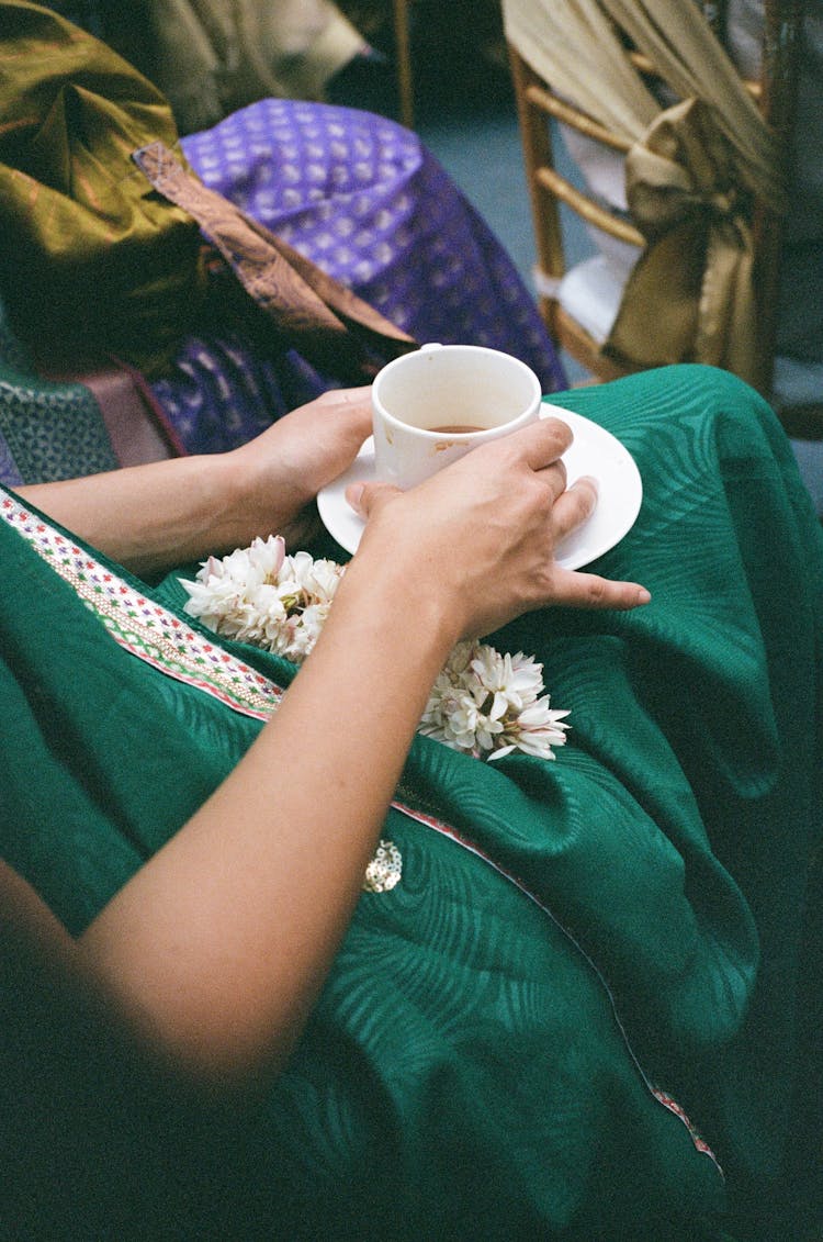 Woman In A Green Dress Drinking Coffee