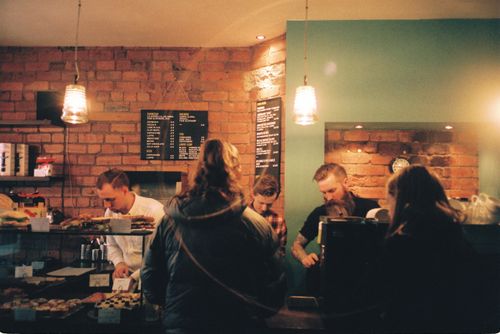 Free A bustling coffee shop in Leeds, England, with customers ordering and baristas preparing drinks. Stock Photo