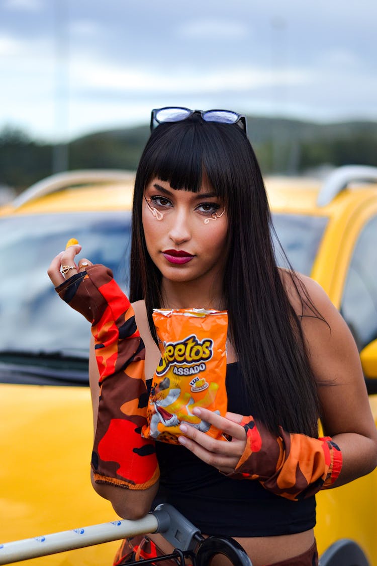 Woman Wearing Sunglasses Eating Chips