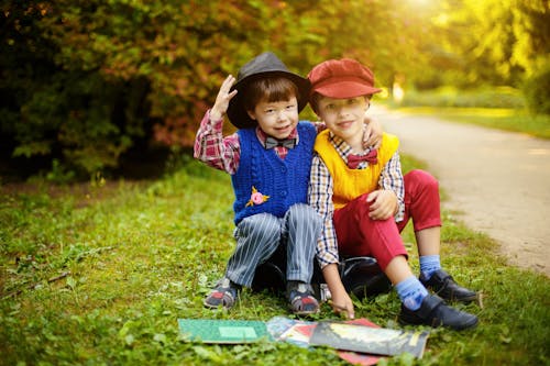 Free Boys Sitting On Grass Stock Photo