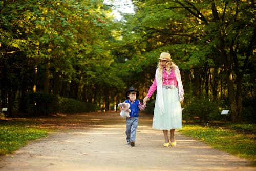 Free Woman Walking With Boy Stock Photo