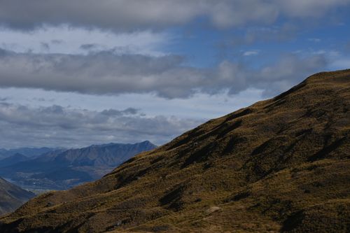 Free Dramatic mountain landscape with rugged hills under a partly cloudy sky. Stock Photo