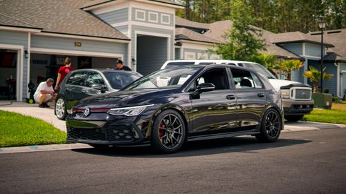Free A modern suburban neighborhood featuring a stylish car parked on a driveway. Stock Photo