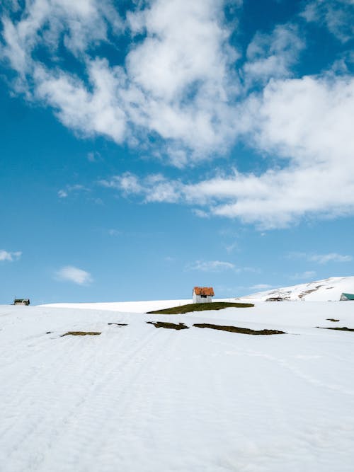 Photo of a Slope against a Cloudy Sky 